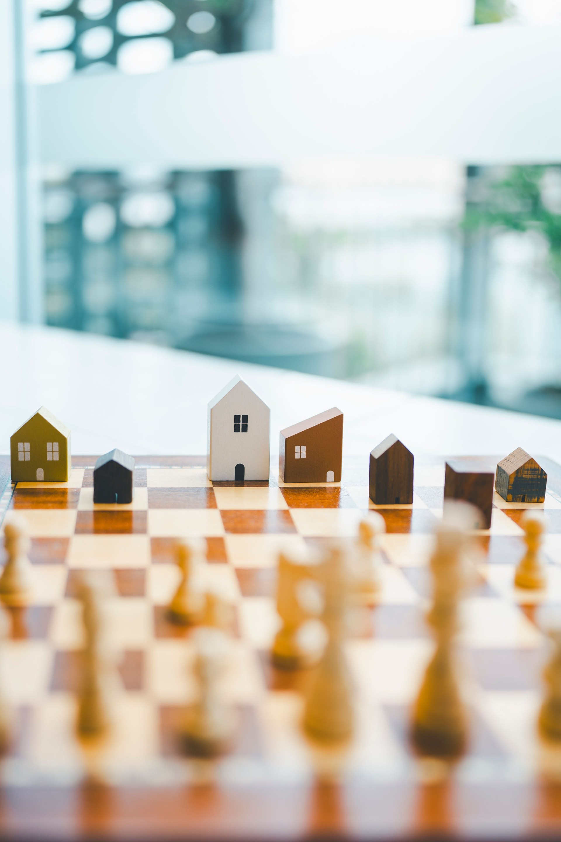 Chess and house models in chess game, competition success play. strategy, management or leadership concept